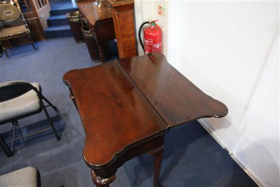 A George II mahogany combined tea, card and games table, H.2ft 6in. W.2ft 7in. D.1ft 4in.